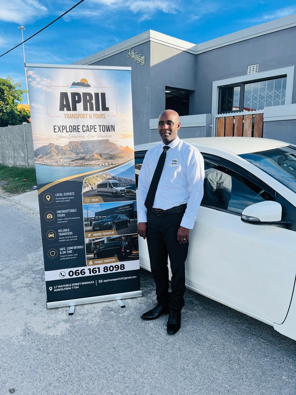 April Transport & Tours chauffeur beside a luxury vehicle in Cape Town